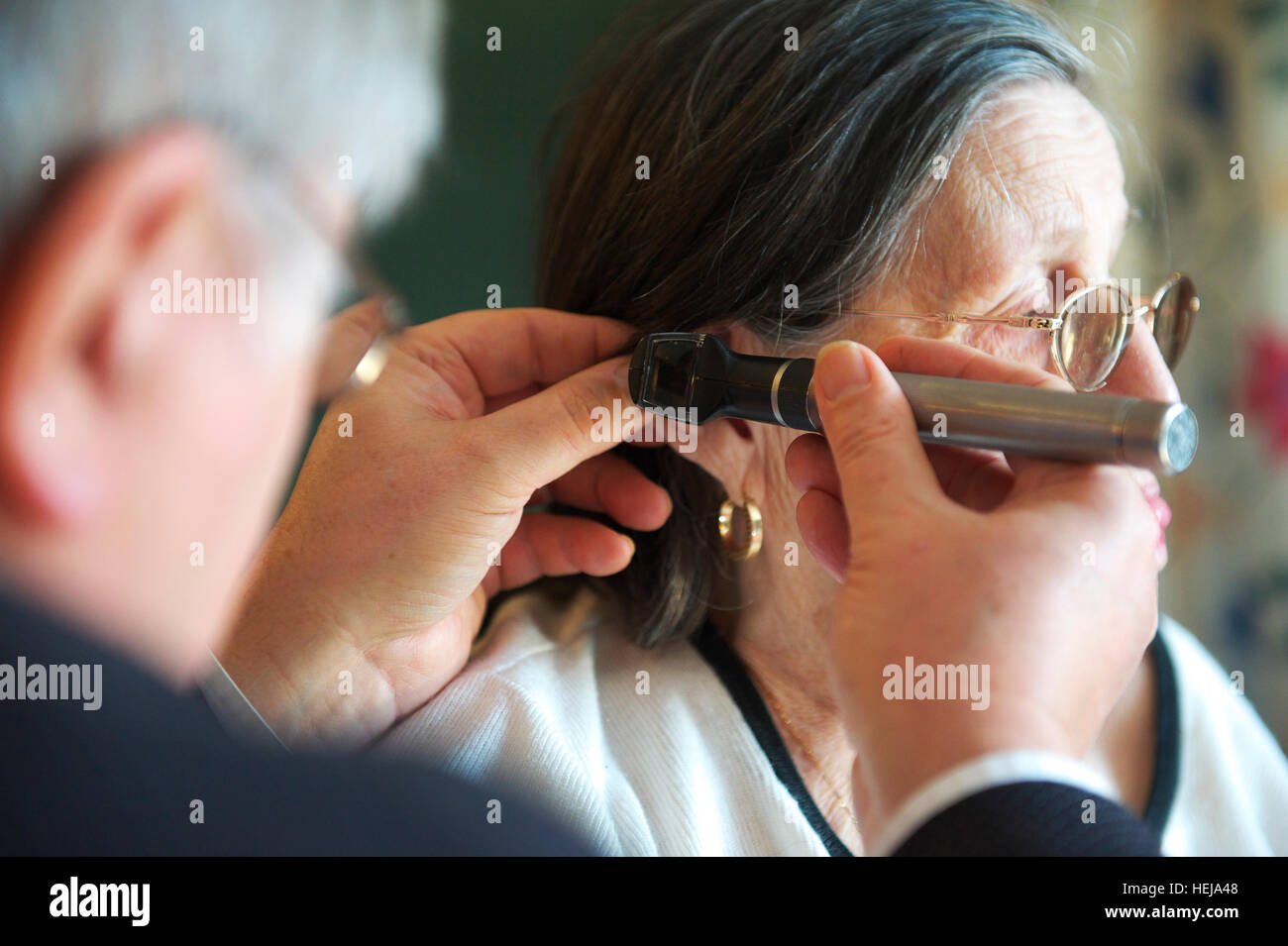 General Practitioner Doctor examines elderly female care home patient