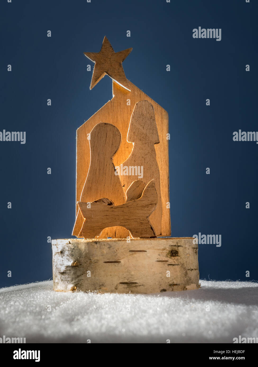 Christmas crib cut out from plywood over dark blue background Stock Photo