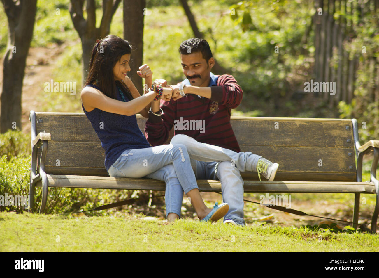Young Married Couple In A Loving Pose Sitting On A Lawn In A Park. Stock  Photo, Picture and Royalty Free Image. Image 24982636.