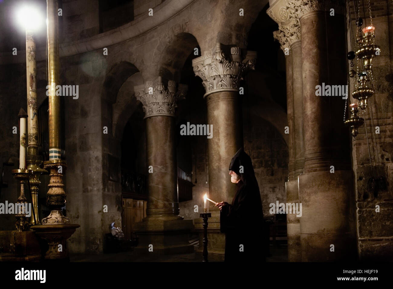 Jerusalem, Israel - May 17, 2014: An Armenian priest traditional night mass in the Church of Holy Sepulchre Stock Photo