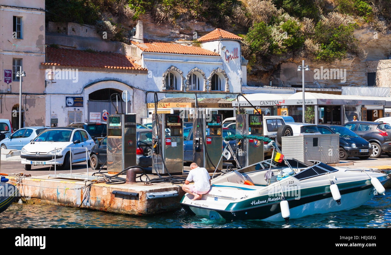 Bonifacio, France - July 2, 2015: Motorboat with ordinary man on boat gas station. Marina of Bonifacio, small resort port city of Corsica island in su Stock Photo