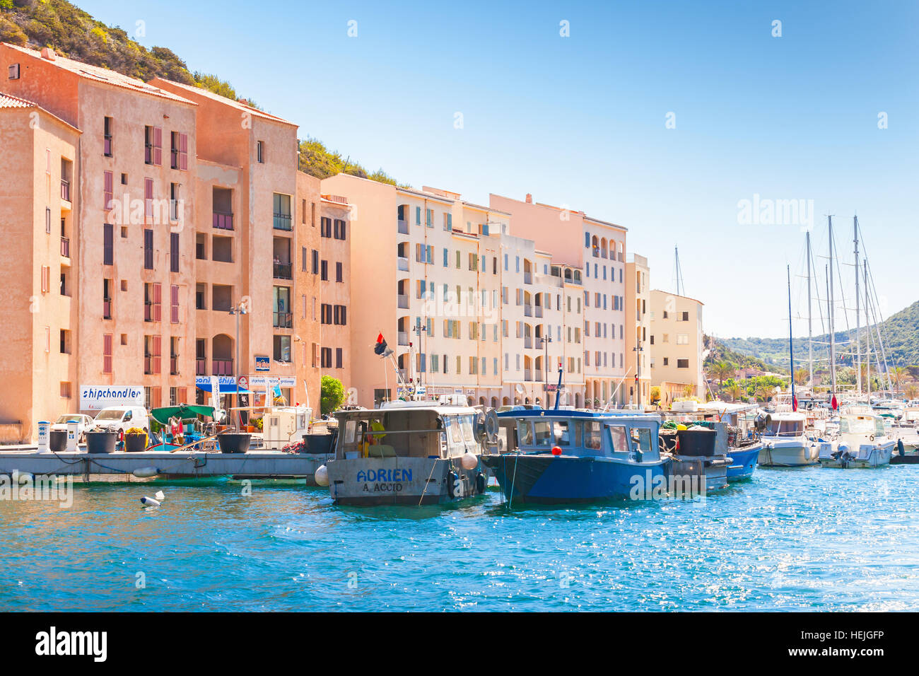 Bonifacio, France - July 2, 2015: Small pleasure boats and sailing yachts are moored near embankment of Bonifacio, small resort port city of Corsica Stock Photo