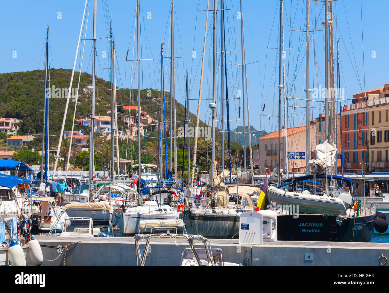Bonifacio, France - July 2, 2015: Pleasure motorboats and sailing yachts are moored in marina of Bonifacio, small resort port city of Corsica island Stock Photo