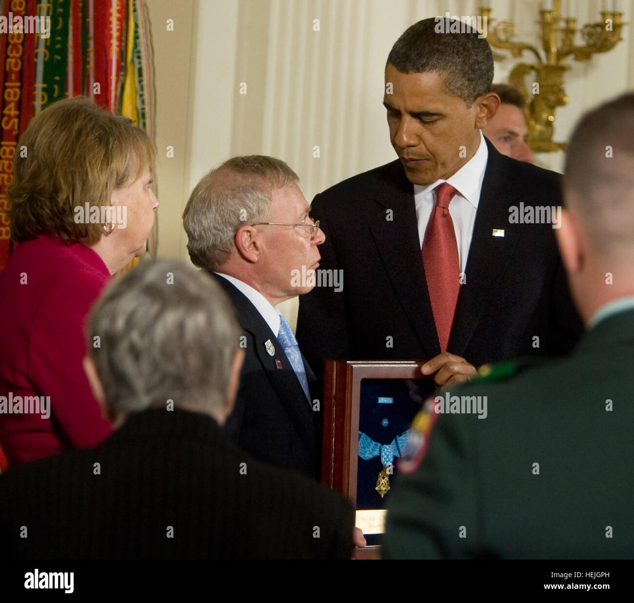 President Barack Obama posthumously awards Army Sgt. 1st. Class Jared C. Monti from Raynham, Mass., the Medal of Honor to his parents Paul and Janet Monti Sept. 17, 2009, in the East Room of the White House in Washington D.C..  ÒJared Monti saw danger before him and he went out to meet it,Ó President Obama said in the ceremony.  Army photo by D. Myles Cullen (released) US Army 50897 President awards Medal of Honor Stock Photo