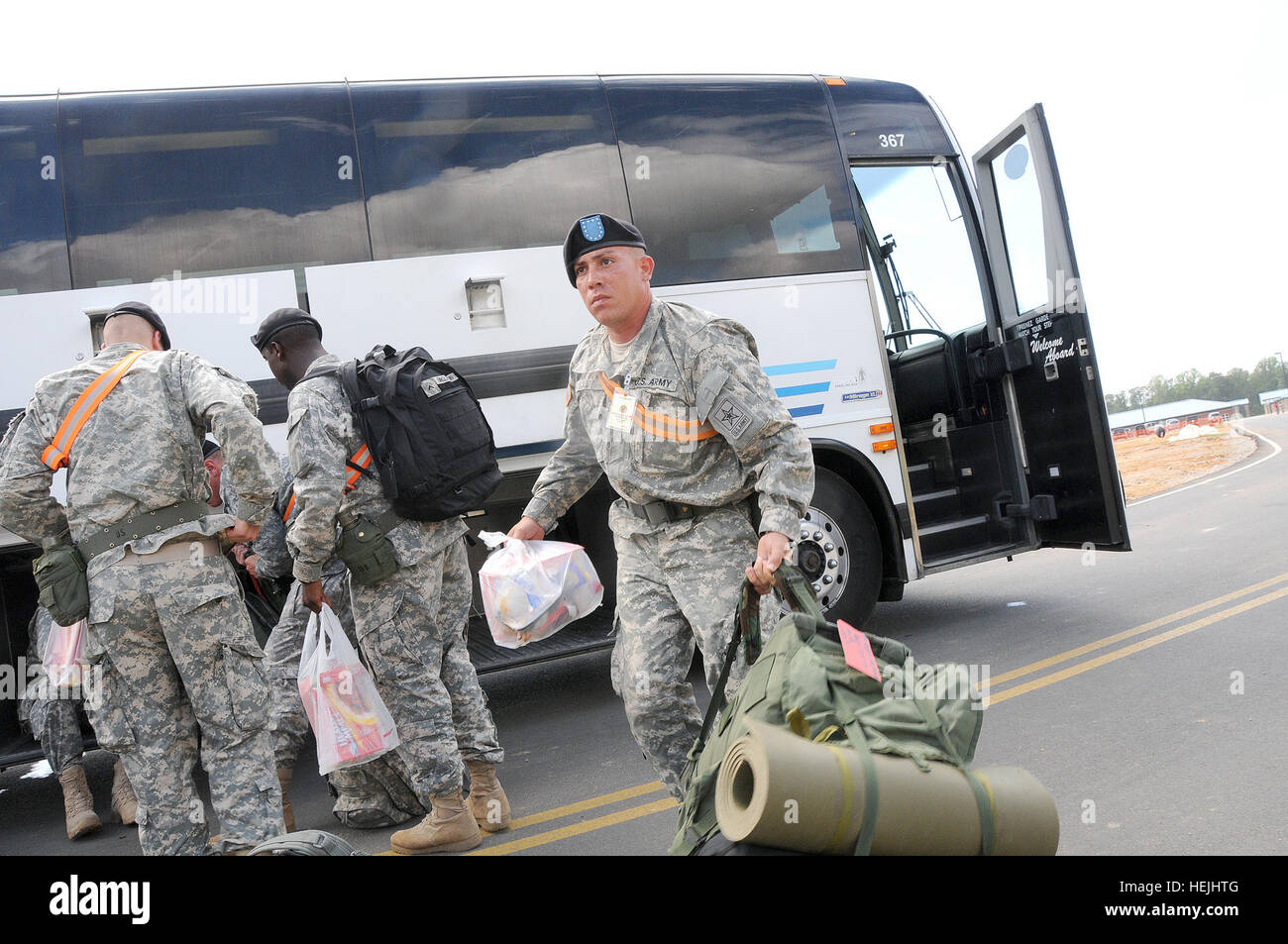 Pvt. Pedro Ruiz moves toward the barracks after arriving by bus from