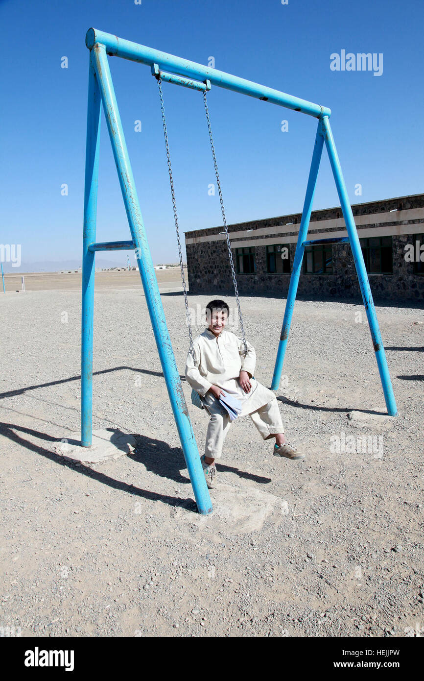 An Afghan boy swings on a swing set at a local school in Zargun Shar,  Afghanistan, Sept. 30. Afghan Soldiers Work With Canadian, French Troops  209909 Stock Photo - Alamy