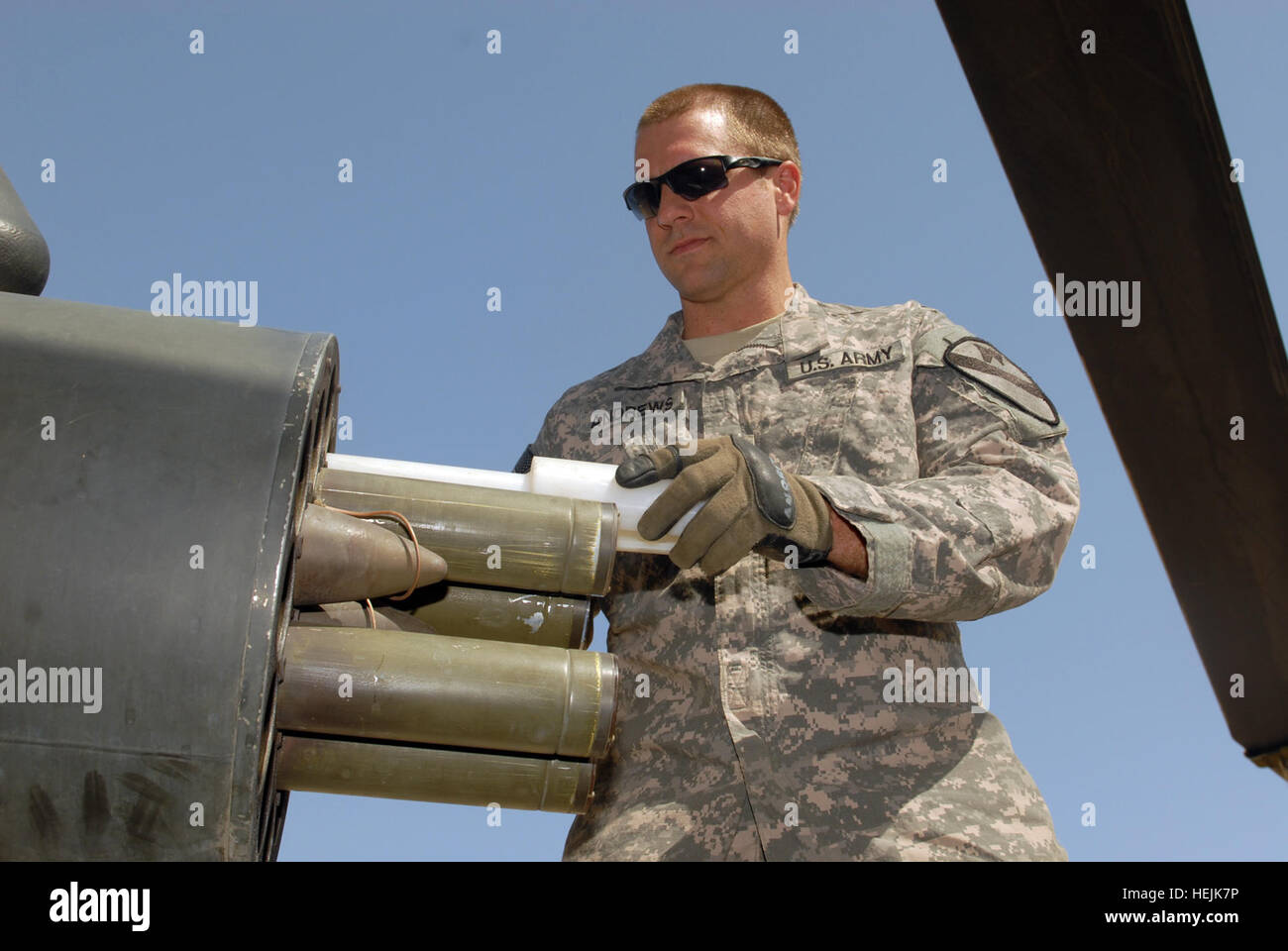 US Army 52455 CAMP TAJI, Iraq - Sgt. Scott Andrews, of West Point, Miss., loads rockets into the rocket pod of an AH-64D Apache helicopter, here, Oct. 1. Gibson is an armament electrical avionics repairer assigned Stock Photo