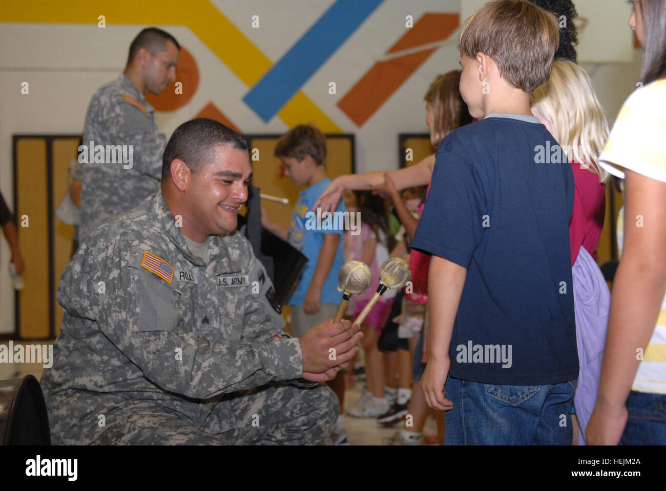 GUANTANAMO BAY, Cuba – Army Sgt. Jose Rojas and Army Staff Sgt. William Cruz, assigned to Joint Task Force Guantanamo and members of Puerto Rican Fever, an all-Soldier steel drum band, display their steel drums and allow students to play them after a performance at W.T. Sampson Elementary School, Oct. 6, 2009. The six-member steel drum band was asked to perform during Hispanic Heritage Month to educate and entertain the children and teach them about Hispanic music and culture. JTF Guantanamo conducts safe, humane, legal and transparent care and custody of detainees, including those convicted b Stock Photo