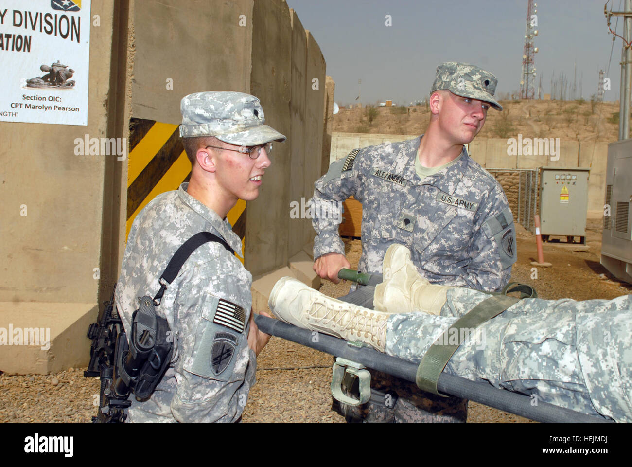 US Army 52950 CAMP LIBERTY - Spc. Christopher Myers (left), of Lowell, Ark., and Spc. Christopher Alexander, of Alma, Ark., load a litter onto an ambulance outside the Division Special Troops Battalion aid station Stock Photo