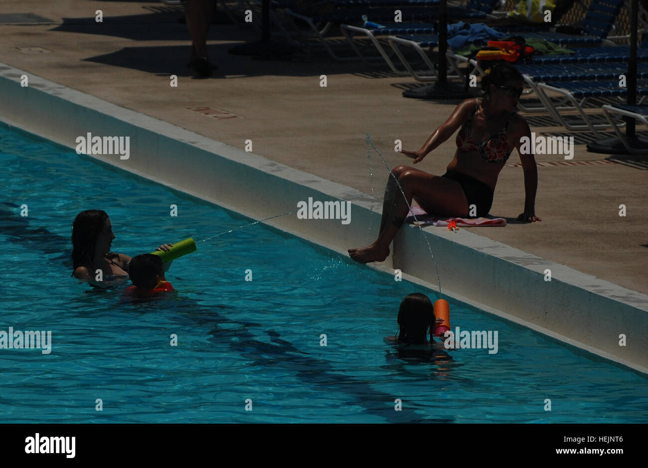 Children take aim at a poolside sunbather at the summer opening of the Kelley Hill pool