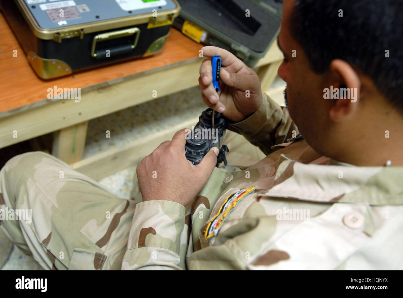 An Iraqi special operation forces soldier tightens a screw on a set of night vision goggles at the 3rd Support Battalion's newly-formed night vision equipment repair shop located on a military compound in Baghdad, May 19. New night vision maintenance shop allows 'Iraqi Special Operations Forces to own the night' 176998 Stock Photo