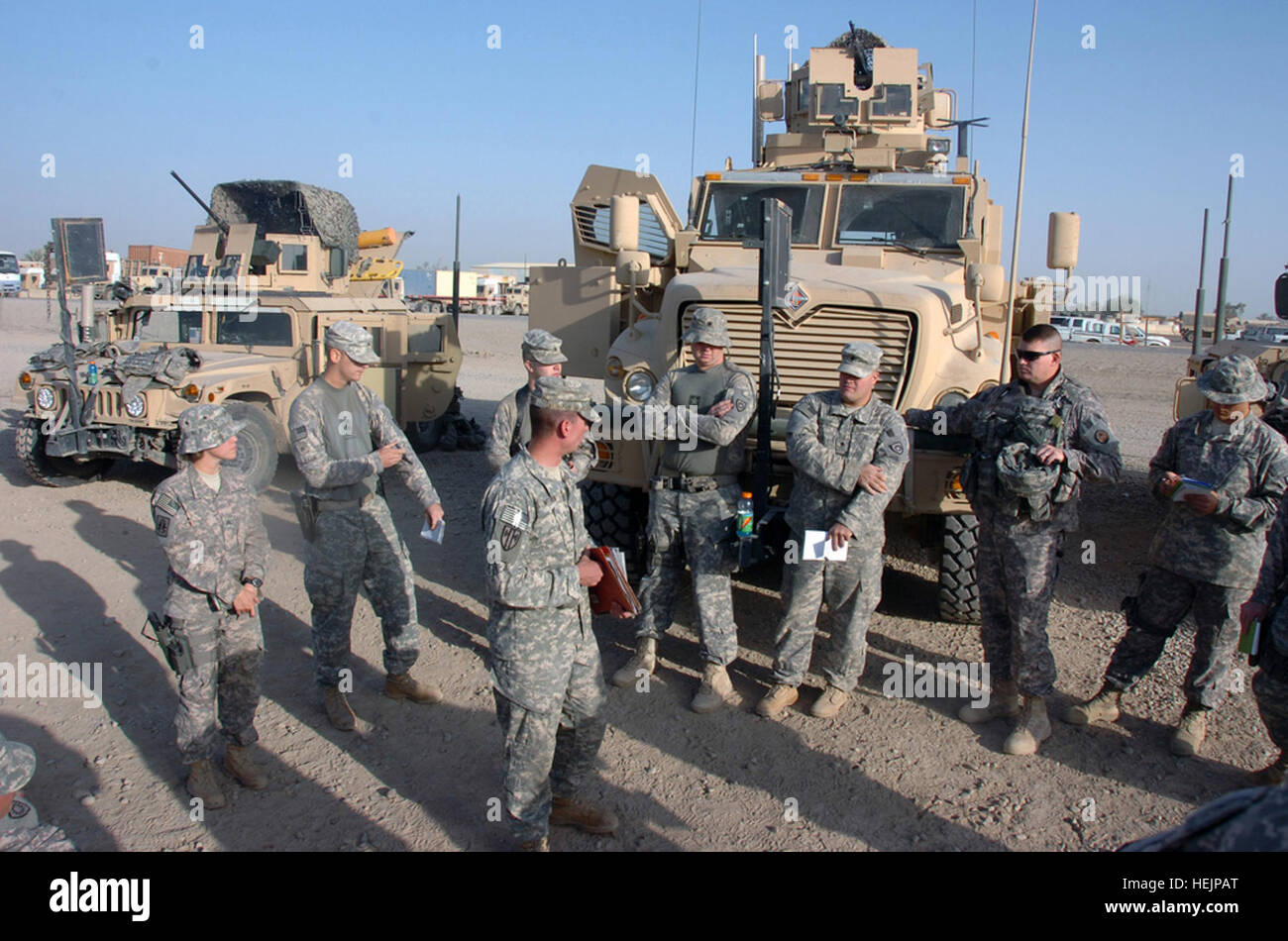 Citizen-Soldiers with the Kentucky National Guard's 223rd Military Police Company conduct a briefing at Camp Liberty, Iraq, before an escort mission in 2008 in front of their vehicles. The undersecretary of defense for policy told a House Armed Services Committee hearing on military redeployment from Iraq Oct. 21, 2009, that reserve component equipment will not be used as a source for Iraqi security forces requirements, adding that units being offered the opportunity to take theater-provided equipment back to their home station. National Guard equipment will return home from Iraq, House Armed  Stock Photo