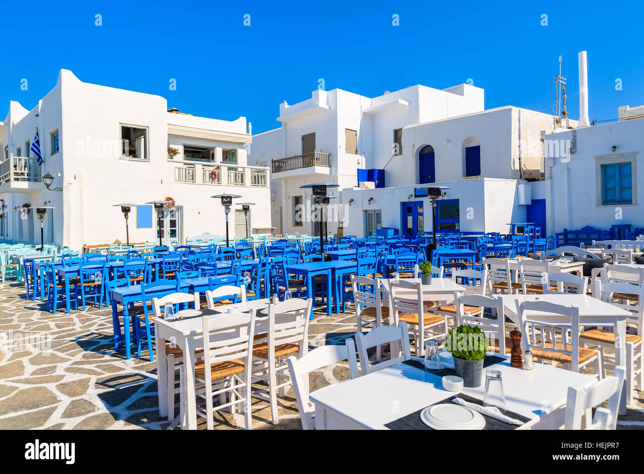 White and blue taverna tables on square in Naoussa port, Paros island, Greece Stock Photo