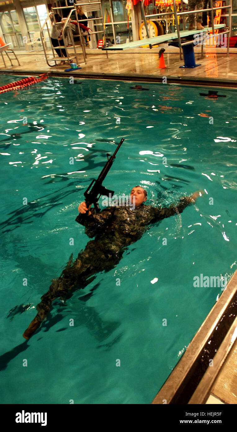 A Soldier with the 2nd Brigade Combat Team, 101st Airborne Division, (Air Assault) keeps his weapon above the water's surface during the combat water survival and confidence assessment portion of the Strike Ranger Assessment Program while at Gardner Indoor Pool, Dec. 3. The brigade's program is a weeklong process done every month to select which Soldiers will represent the Strike Brigade at the extremely difficult U.S. Army Ranger School. Strike Prepares Its Soldiers for Ranger School 239573 Stock Photo