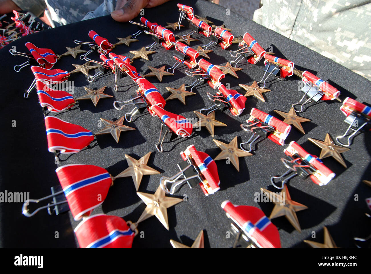 Bronze Star medals are displayed in rows prior to a ceremony on Forward