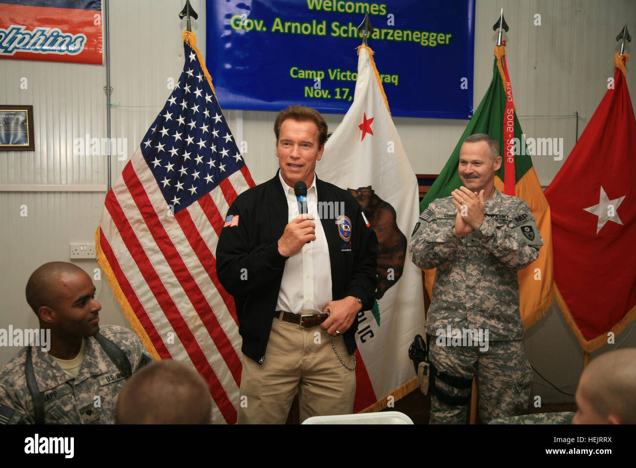 California Gov. Scharzenegger greets Soldiers from the California National Guard, 49th Military Police Brigade, headquarters company, at the Oasis dining facility, Nov. 15, Camp Victory, Iraq. The governor's  planned  stopped over included visits to Morale, Wellfare, and Recreation, (MWR), locations throughout the Victory Liberty Complex. At right is 49th commander Donald Currier, a native of Folsom, Calif., and personal friend to the governor.(U.S. Army photo by Sgt. Kenneth Bince) Governor Schwarzenegger has breakfast with California Soldiers in Iraq 224244 Stock Photo