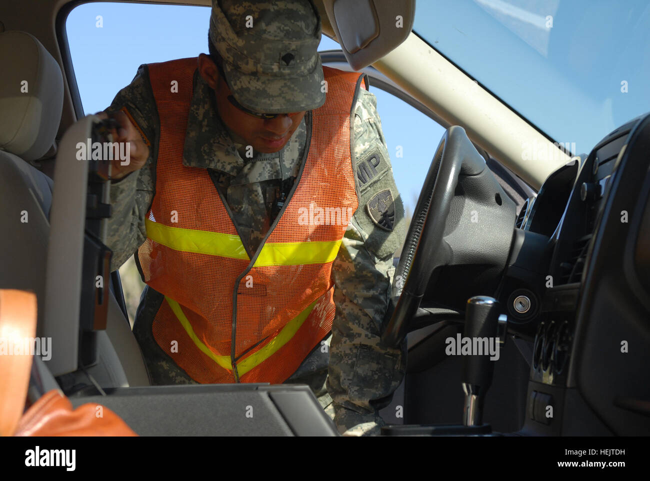 Military Police conduct random vehicle inspections at an entry control ...
