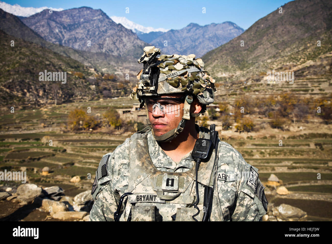 U.S. Army Capt. Albert 'Paco' Bryant, from Washington, D.C., commander of Combat Company, 1st Battalion, 32nd Infantry Regiment, 3rd Brigade Combat Team, 10th Mountain Division, stands on a hill top with the Shigal Valley as a backdrop during a patrol in the village of Lachey in the Shigal district of Kunar province, Afghanistan on Dec. 7. OperationEnduringFreedom-SGTTeddyWadePhotographs-03 Stock Photo