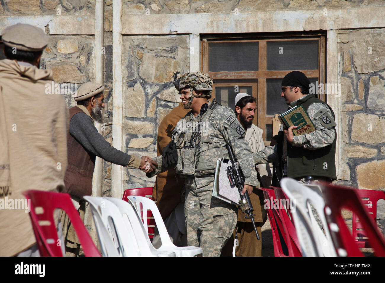 U.S. Army Capt. Albert 'Paco' Bryant, from Washington, D.C., meets with Afghan locals before a shura at the village of Lachey in the Kunar province, Afghanistan on Dec. 7. Bryant is the commander of Combat Company, 1st Battalion, 32nd Infantry Regiment, 3rd Brigade Combat Team, 10th Mountain Division. OperationEnduringFreedom-SGTTeddyWadePhotographs-05 Stock Photo