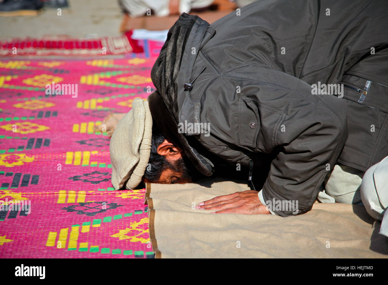 An Afghan man bows and kisses the ground during a noontime prayer at the Lachey Village in the Shigal district of Kunar province, Afghanistan on Dec. 7. Operation Enduring Freedom 232633 Stock Photo