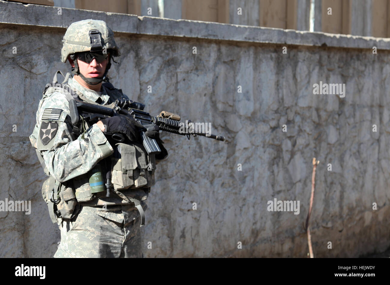 U.S. Army Sgt. Robert L. Jones, assigned to D Company, 2-12 Infantry Regiment, 4 Brigade Combat Team, 4 Infantry Division, provides security at a Kandigal village school during a meeting with Afghan elders in Kunar province, Afghanistan, Dec. 15. Operation Enduring Freedom 234746 Stock Photo