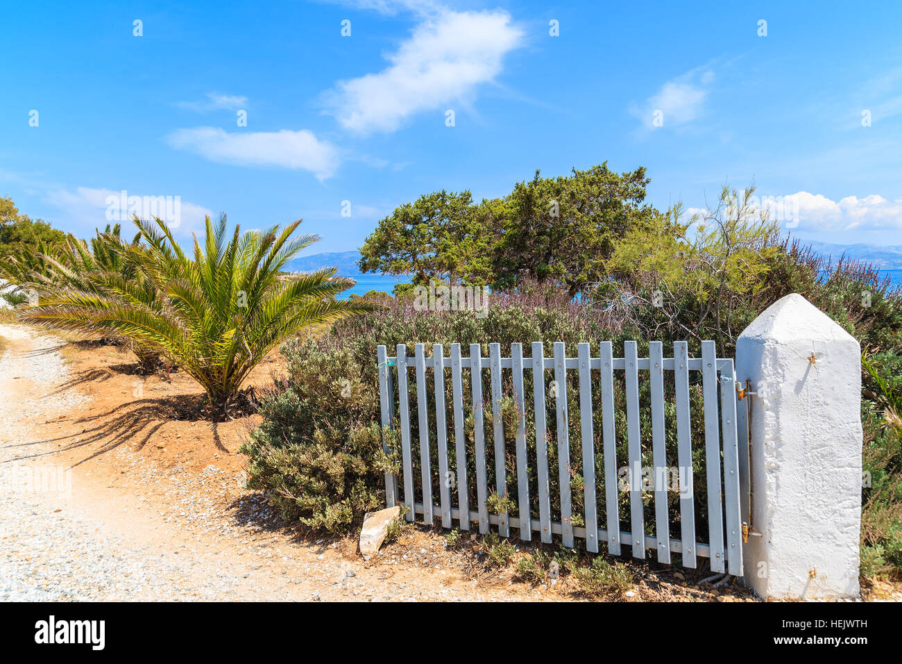 Gate to beach in coastal road along sea in Ampelas village on Paros island, Greece Stock Photo