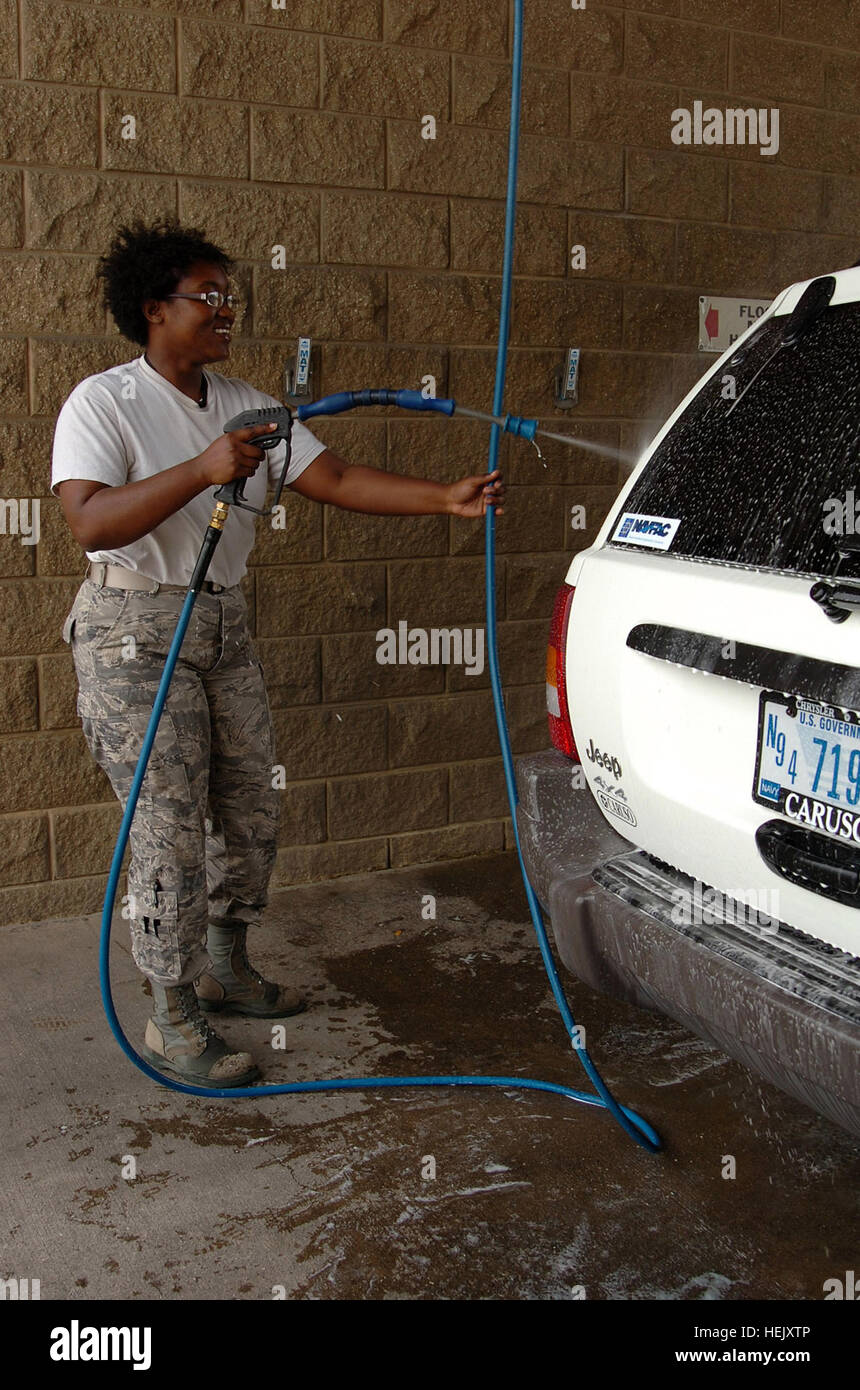 GUANTANAMO BAY, Cuba – Air Force Staff Sgt. Andrea Penn, the housing non-commissioned officer in charge for the Commissions Support Group, washes her government vehicle at U.S. Naval Station Guantanamo Bay, Jan. 11, 2010.  The CSG maintains temporary lodging at Camp Justice to support Joint Task Force operations and house personnel arriving with the Office of Military Commissions as well as defense lawyers. JTF Guantanamo conducts safe, humane, legal and transparent care and custody of detainees, including those convicted by military commission and those ordered released by a court. The JTF co Stock Photo