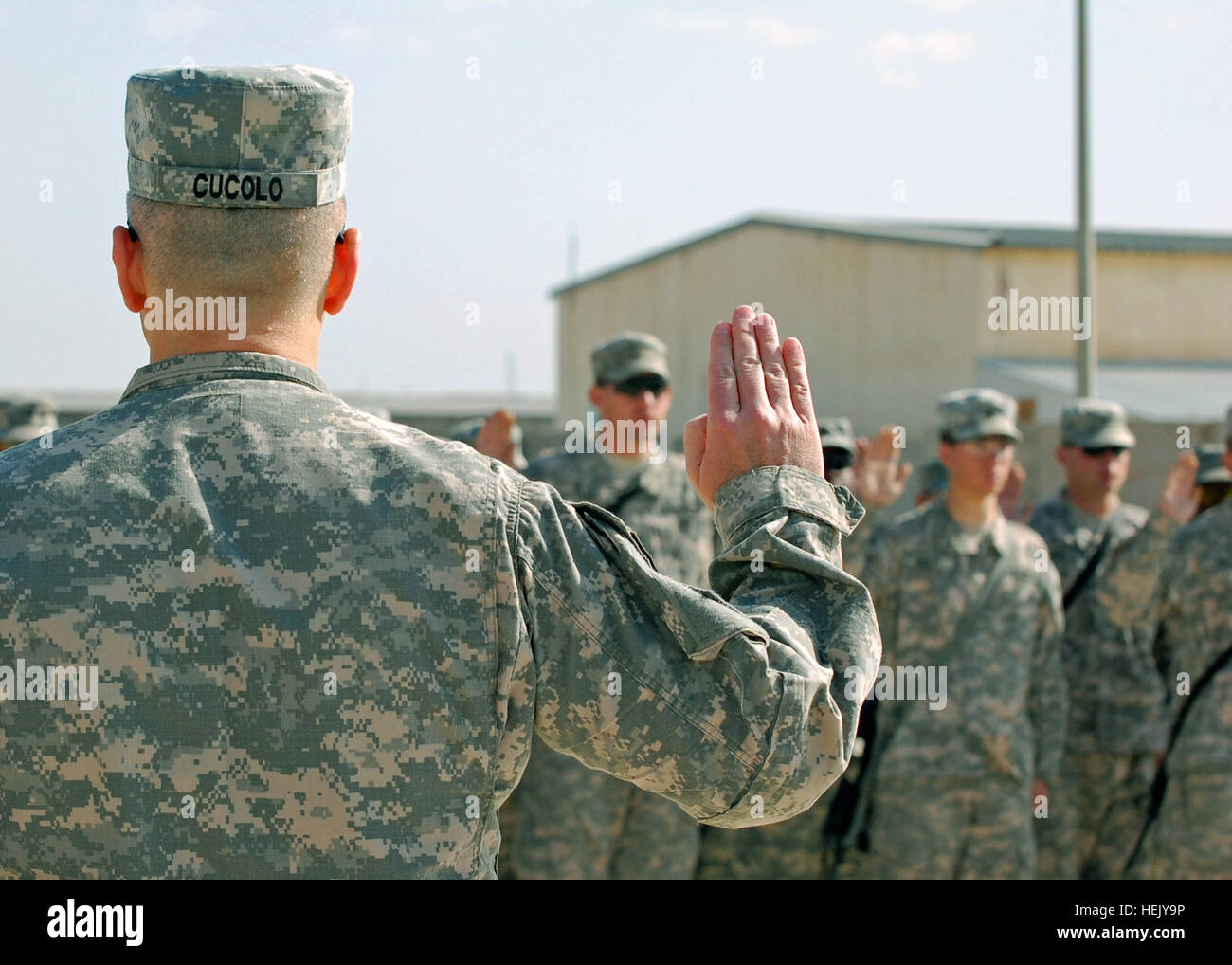 Maj. Gen. Tony Cucolo III, commander of 3rd Infantry Division, re-enlists 46 Soldiers of 1st Brigade Combat Team-Augmented, 3rd ID, Jan. 25 at Contingency Operating Station Falcon. (U.S. Army photo by Sgt. Mary Katzenberger, HHC 1BCT-A 3ID, USD-C) Raider soldiers re-enlist to 'stay Army' 244875 Stock Photo