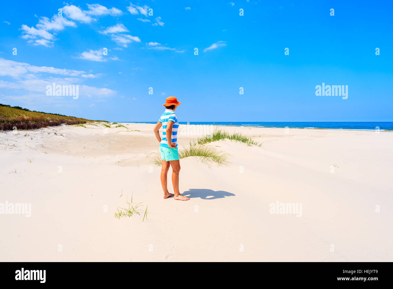 Young woman tourist standing in white sand on Debki beach, Baltic Sea, Poland Stock Photo