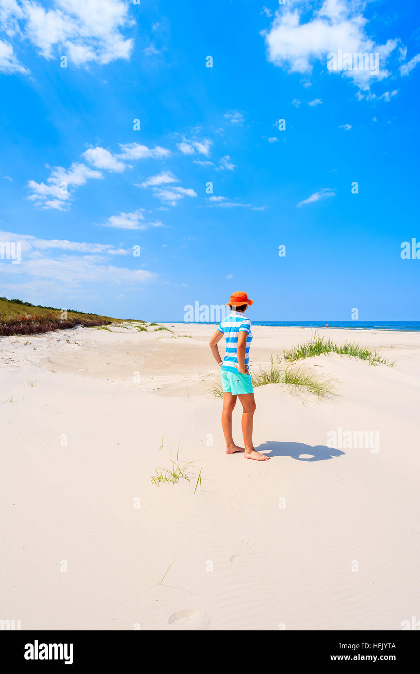 Young woman tourist standing in white sand on Debki beach, Baltic Sea, Poland Stock Photo