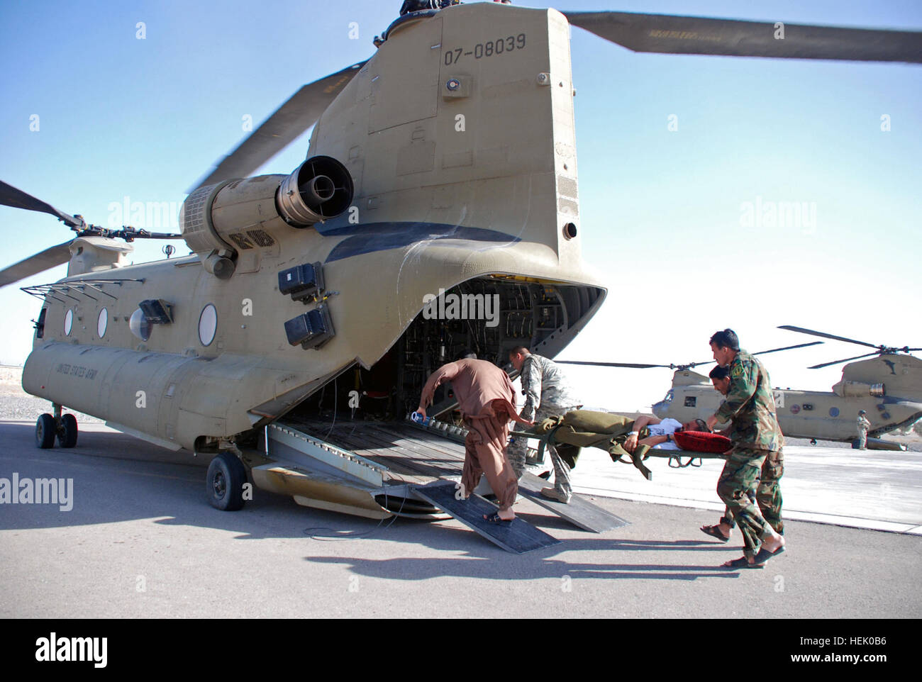 Medical personnel from Kandahar Regional Military Hospital carry a injured Afghan patient onto a CH-47F Chinook helicopter from Company B, 3rd Battalion, 82nd Aviation Regiment, during a patient transfer to a hospital in Helmand province. Chinook patient transfer supports Operation Moshtarak 253645 Stock Photo