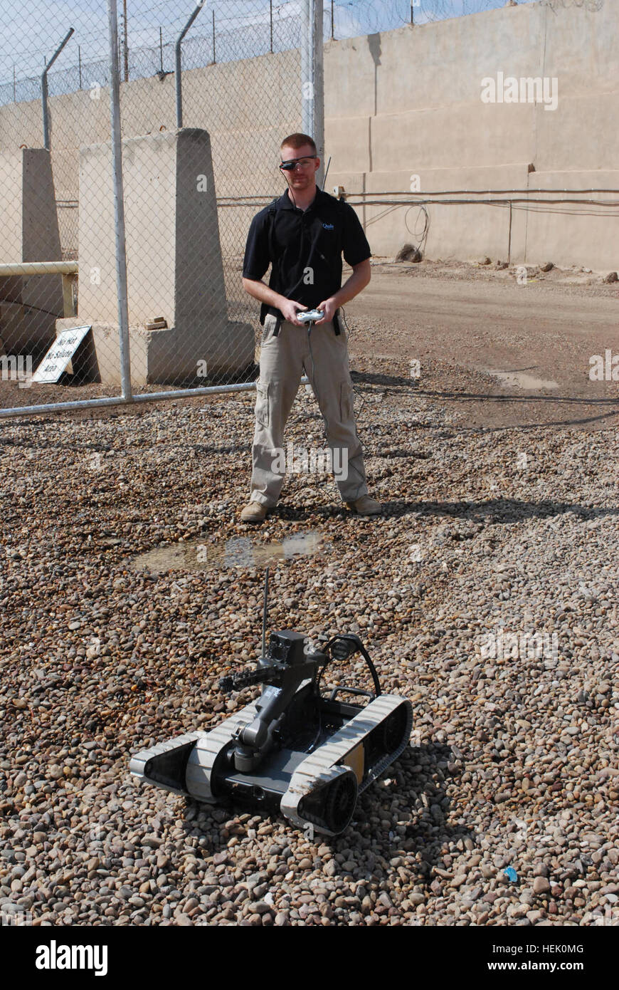 Shawn Wyzlic, a robot technician for the Joint Robotics Repair Detachment and native of Wixom, Mich., tests a robot used to disarm and identify explosives at the Joint Robotics Repair Facility on Camp Victory, Baghdad, Iraq, March 2, 2010. The robots come to the facility when needing repairs or a unit is leaving Iraq so they can be cleaned and given to another unit in need of them. Joint Robotics Repair Detachment keeps robots mission ready 269089 Stock Photo