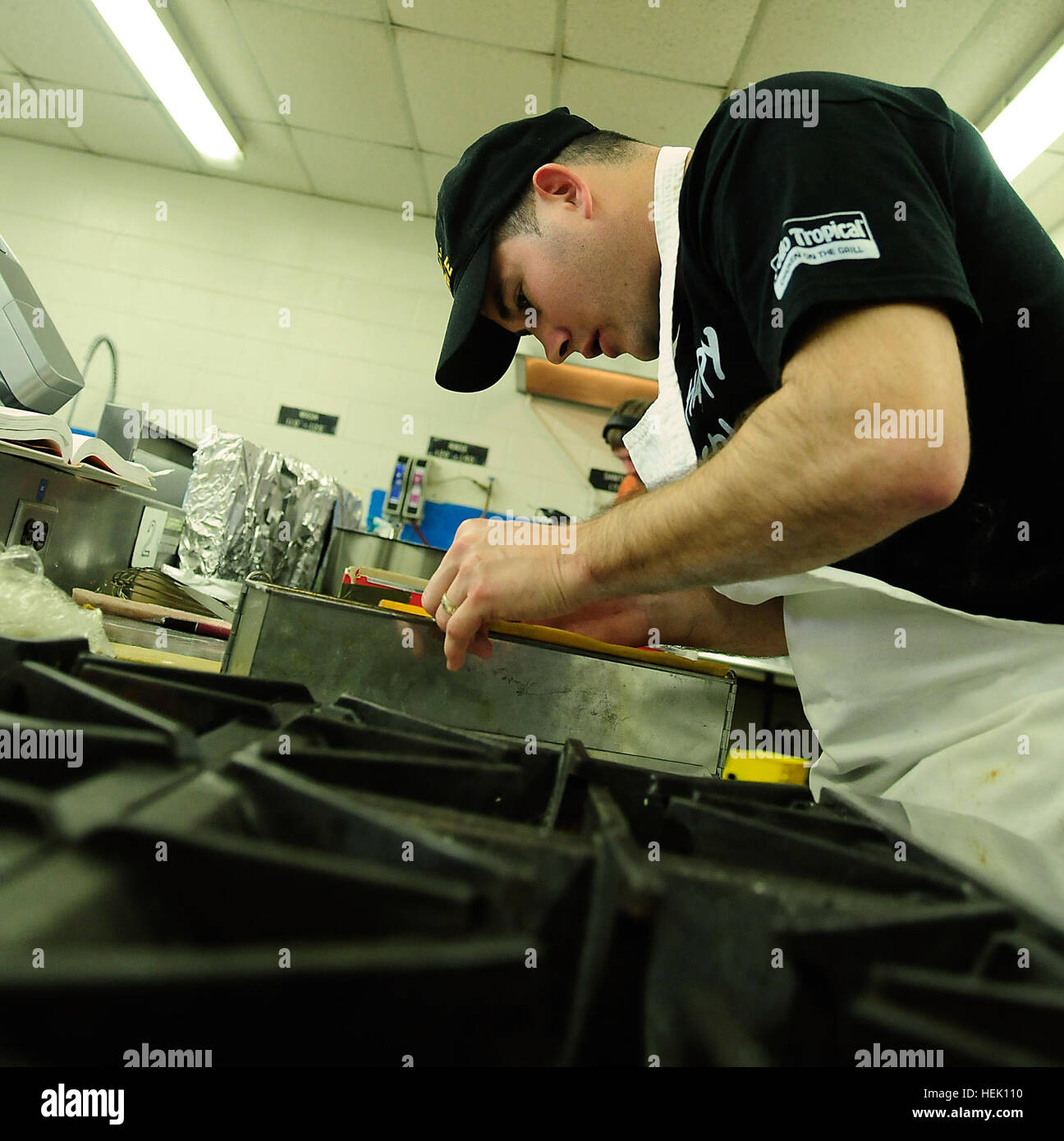 Army Reserve Staff Sgt. Joseph Parker prepares items for the table display in the team's kitchen at the 35th U.S. Army Culinary Arts Competition at Fort Lee, Va., Monday, March 8. Parker, from Haines City, Fla., is assigned to the 841st Combat Engineer Battalion based in Miami, Fla.The table display will be set up in the Post Field House and incorporates a 12-foot by 12-foot display that will feature a variety of items to include cold buffet platters, centerpieces, petit fours, along with marizpan, fondant, tallow, chocolate and salt dough sculptures. Behind the scenes with the Army Reserve at Stock Photo