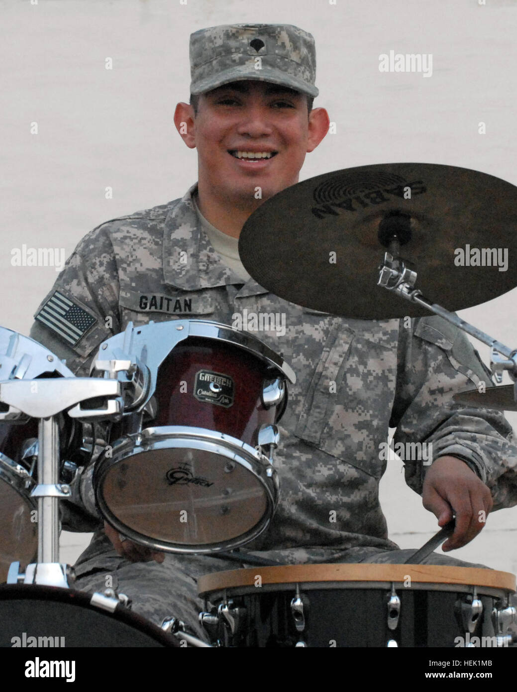 Specialist Eisner J. Gaitan, a drummer with the 3rd Infantry Division Band, jams away during a jazzy brass compilation with five other band members in the Night Shift Brass Band entertaining people at the beginning of the Division Special Troops Battalion Women's History Month 6K run and walk at the main stadium stage on Contingency Operating Base Speicher, near Tikrit, Iraq, March 28. HTNR Spc. Eisner J. Gaitan 268714 Stock Photo