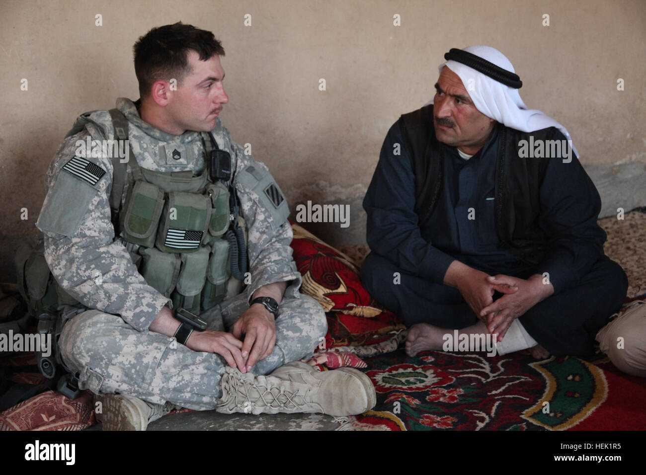 U.S. Army Staff  Sgt. Samuel Winkler, Charlie Troop, 3rd Squadron, 7th Cavalry Regiment, 2nd Brigade Combat Team, 3rd Infantry meets with Mayor Nawaf Solaiman Ahmed in Al Dirnaj, Iraq, April 1. They will discuss any concerns that the mayor has within the town. School visit 269906 Stock Photo