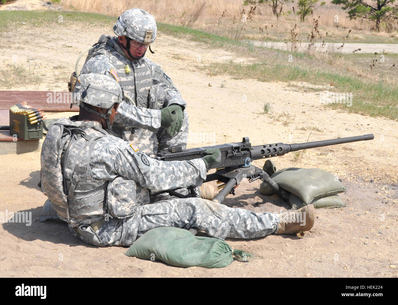 NCO winner checks M-2 machine gun 100408-A-4429M-007 Sgt. 1st Class Bobby Williams, from Water Valley, Miss., and a member of the 1st of the 307th Battalion, 72nd Field Artillery (FA) Brigade, checks his M-2, .50 caliber machine gun before firing at targets at Army Support Activity-Dix (ASA-Dix) during a part of the 2010 72nd FA Bde. NCO of the Year competition April 8. Williams won the event and will go on to compete at the 1st Army Division East level at Fort Knox, Ky., May 3-6. Next to Williams is his sponsor, Master Sgt. Phillip Johnson, from Hindman, Ky., and a member of the 1st of the 30 Stock Photo