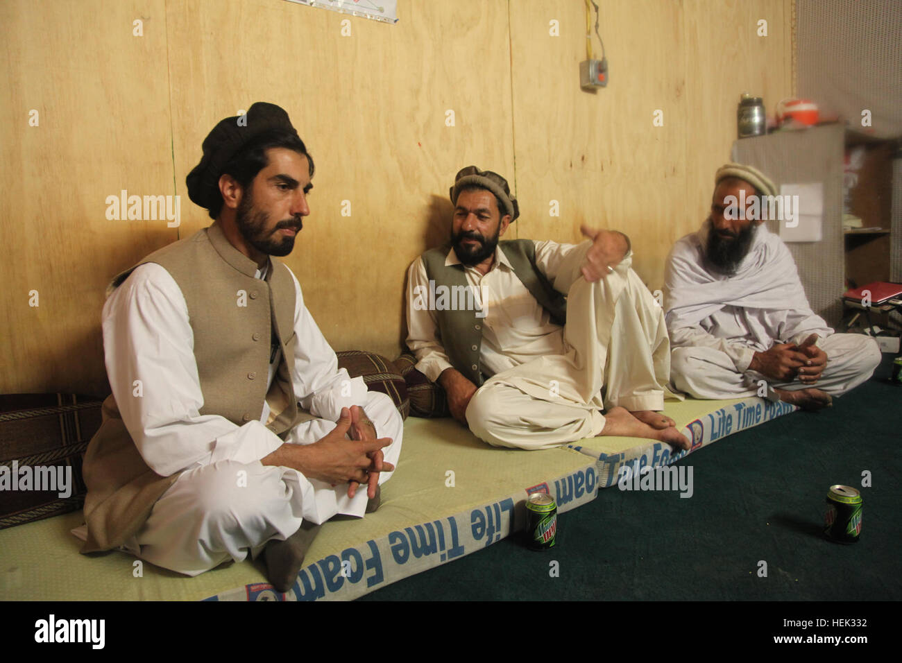 The incoming sub-governor of the Noorgal district, Rama Tullah (left), sits with the chairman of the District Development Assembly, Akram Khan (middle) and another member of the DDA during a shura on COP Fortress,  May 4, Konar province, Afghanistan. This meeting was to discuss a building project that caused flooding into a local school in a nearby village. Operation Enduring Freedom 276479 Stock Photo