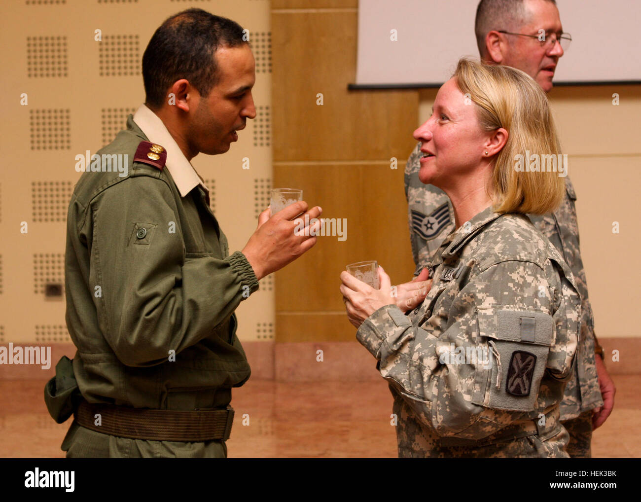 Staff Sgt. Anette Aldridge of West Jordan, Utah, a French linguist serving with Company C, 142nd Military Intelligence Battalion, Utah Army National Guard, talks with a colonel of the Moroccan Army after a chemical awareness presentation given at the Moroccan military's South Command Headquarters in Agadir, May 16. Aldridge, along with other French and Arabic linguists of the 142nd MI Bn., were attached to the 151st Expeditionary Medical Group, Utah Air National Guard, to assist them as translators during humanitarian missions conducted as part of Exercise AFRICAN LION 2010. (U.S. Army photo b Stock Photo
