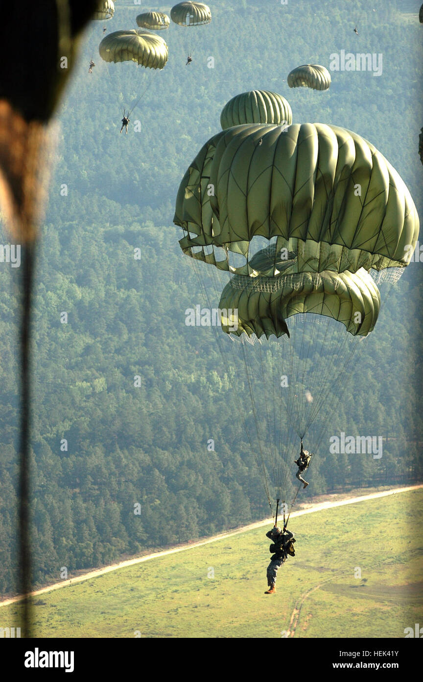Paratroopers fly through the air after jumping from the tailgate of a C