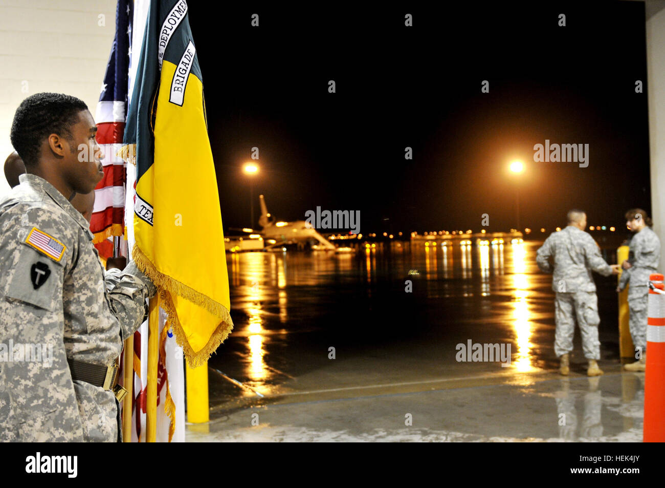 In this image released by the Texas Army National Guard, Spc. Daniel McMurray of Bryan, Texas, with the Honor Guard for the Mobilization and Deployment Brigade out of Fort Bliss, El Paso waits to welcome Soldiers with Alpha and Bravo Company, 1st Battalion of the 141st Infantry Regiment, 72nd Infantry Brigade Combat Team, home after their arrival at Biggs Airfield, Fort Bliss, Texas, July 12. The two units are returning from Camp Victory, Baghdad after deploying to Iraq with the 72nd IBCT in December 2009. The soldiers performed a variety of security missions, including fixed site and convoy o Stock Photo