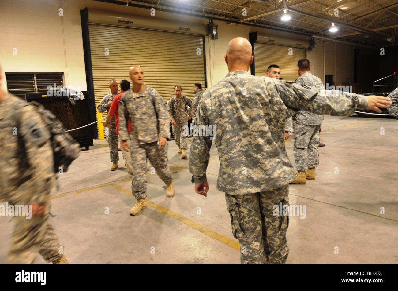 In this image released by the Texas Army National Guard, combat medic Sgt. 1st Class Trenton Puckett, from San Antonio, of the Headquarters Company, 1st Battalion of the 141st Infantry Regiment, 72nd Infantry Brigade Combat Team, soldiers with the Alpha and Bravo Company, 1/141 into the correct check-in line after arriving at Biggs Airfield, Fort Bliss, Texas, July 12. Puckett is part of the advanced party sent to Fort Bliss to facilitate the 72nd IBCT movement back into the U.S. after their Iraq deployment. Alpha and Bravo Company were deployed to Camp Victory, Baghdad in Dec. 2009 and charge Stock Photo