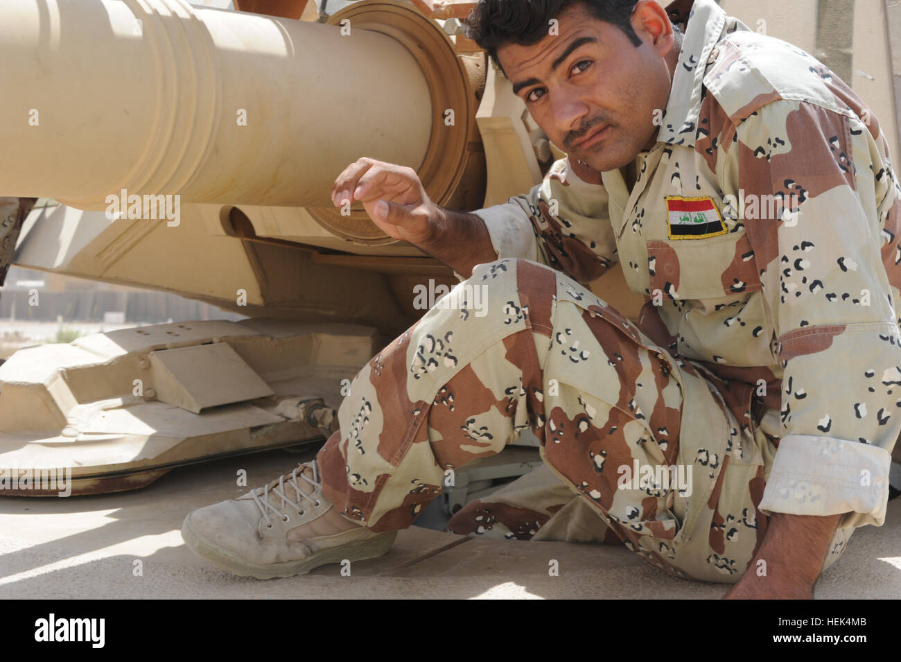 An Iraqi Army tank driver with 9th Iraqi Army Division climbs into the