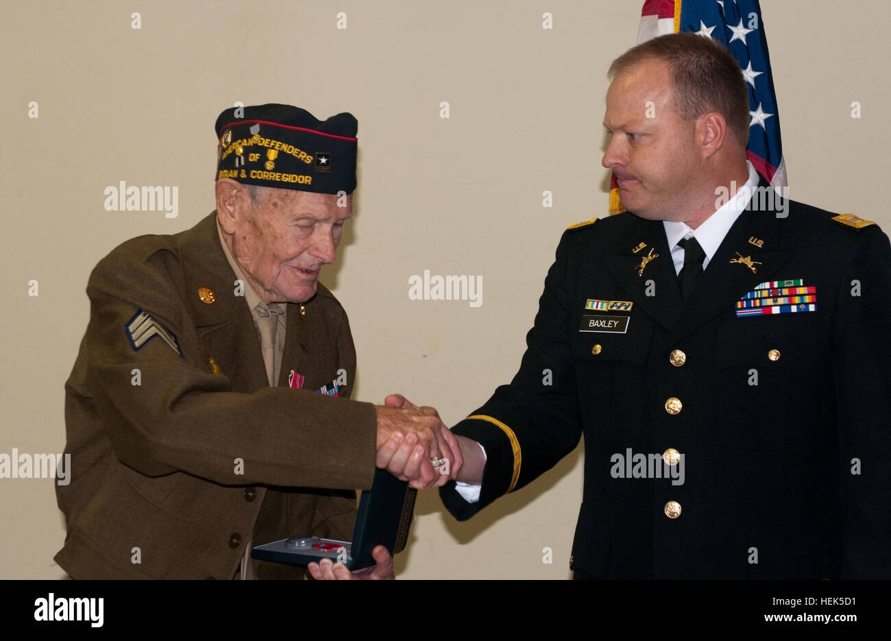 Sgt. Frank Dunlap, an Army Air Corps veteran of World War II, shakes the hand of Capt. David Baxley, administrative officer, 4th Battalion, 118th Infantry Regiment, S.C. Army National Guard, after Baxley presented Dunlap with a Bronze Star Medal, Aug. 15, at Veterans of Foreign Wars Post 10804 in North, Little River, S.C. Dunlap, 87, was presented the Bronze Star Medal for his service during World War II by. After receiving the medal Dunlap said, 'This a huge honor, but I want people to understand I'm not accepting this for me. I'm accepting it on behalf of all the men and women who have serve Stock Photo