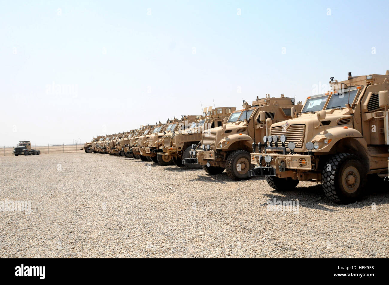 Mine Resistant Ambush Protected vehicles wait in line at the retrogad property assistance team yard on Contingency Operating Base Adder, Iraq. These trucks come from bases throughout southern Iraq to be put onto convoys of flatbed trucks to head south to Kuwait so they can be used by the Army elsewhere. Drawdown Operations in Full-swing for Operation New Dawn 313939 Stock Photo