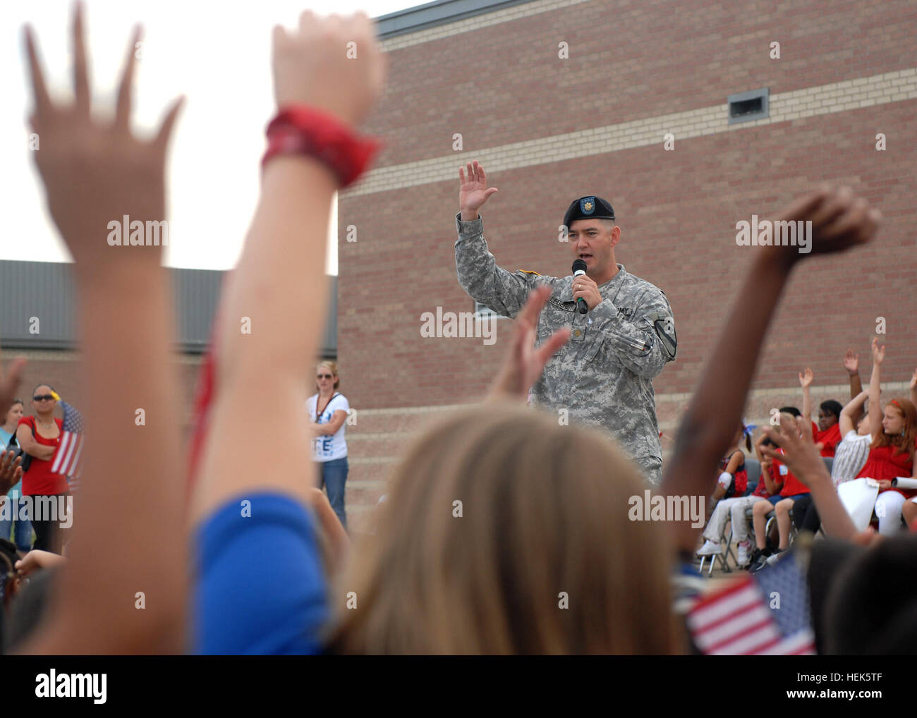 Maj. Dan Legereit, of Metropolis, Ill., the executive officer for 4th Attack Reconnaissance Battalion, 227th Aviation Regiment, 1st Air Cavalry Brigade, 1st Cavalry Division, asks students at Trimmier Elementary School what freedom means to them. Legereit, along with nearly 40 soldiers from 4-227th, visited the school to help the children and faculty memorialize the events of 9/11, Sept. 10. 1st Air Cav, kids celebrate freedom 318596 Stock Photo
