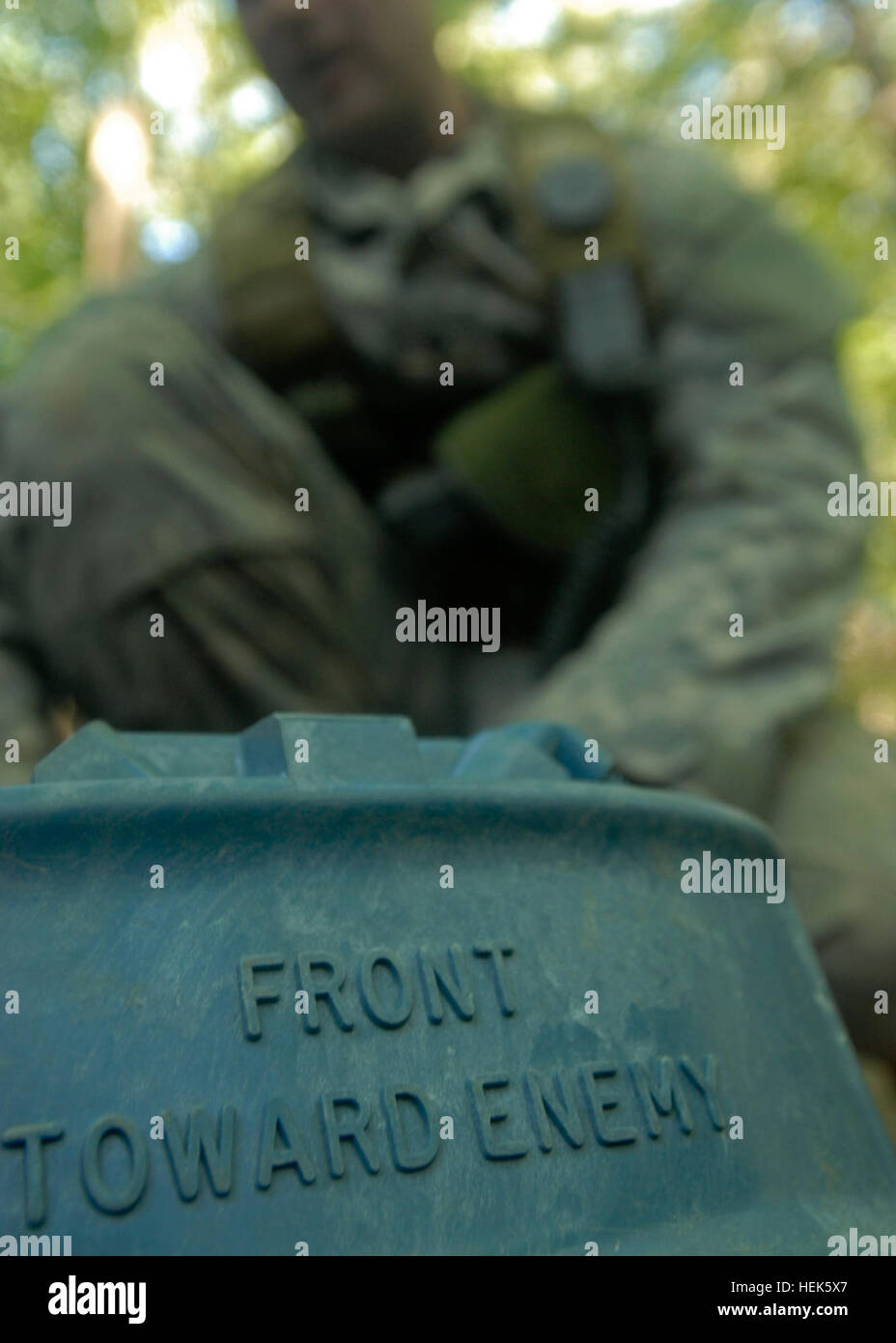 A Special Forces candidate teaches roleplayers about explosives during