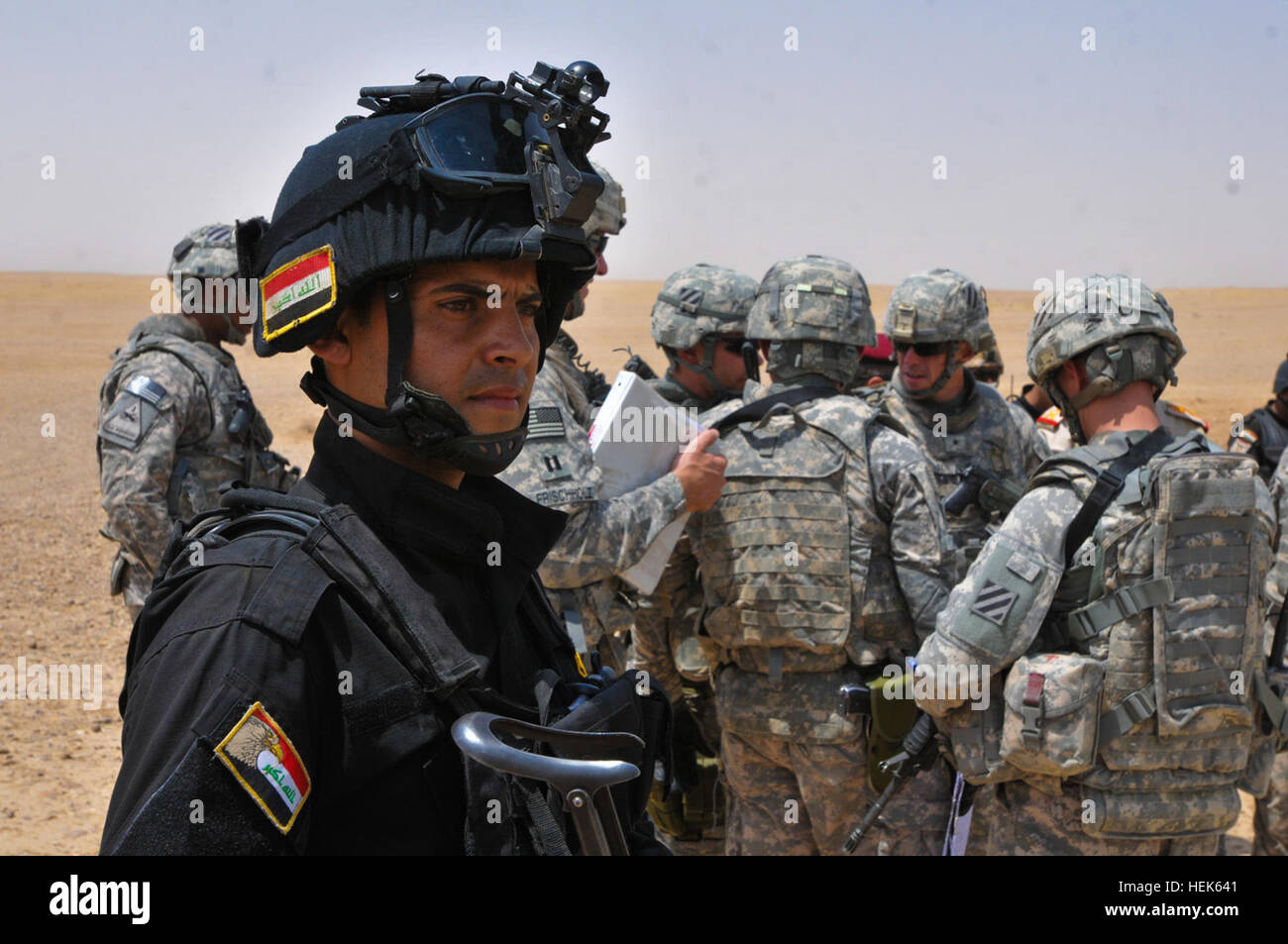 The Iraqi Army and a local SWAT Team work with the 1-9 Field Artillery  Battle Kings, from 2nd Heavy Brigade Combat Team, 3rd Infantry Division, to  coordinate Operation Able Undertaking in the