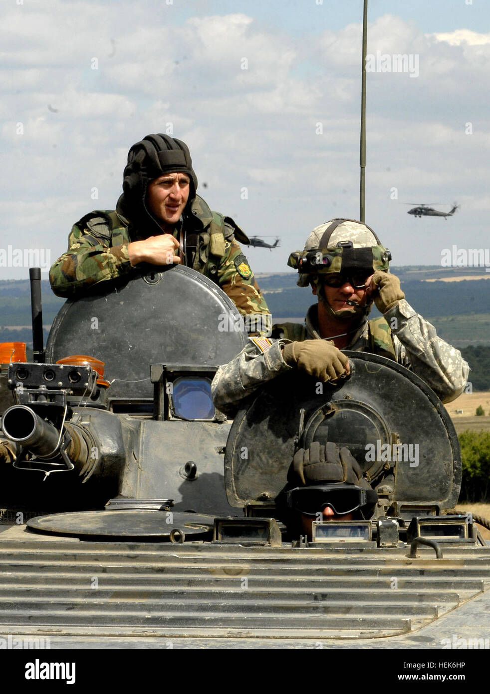 Bulgarian and American Soldiers man the command section of a Bulgarina BMP-1 tracked armored troop carrier during  Military Operations in Urban terrain training at the Novo Selo Training Area, Bulgaria. The MOUT site is a major training site for the tri-lateral exercise Immediate Response 06 involving Soliders from Bulgaria, Romania and the U.S. 17-21 July 2006. (U.S.Army photo byGary L. Kieffer) (Released). US soldier in Bulgarian BMP-1 Stock Photo