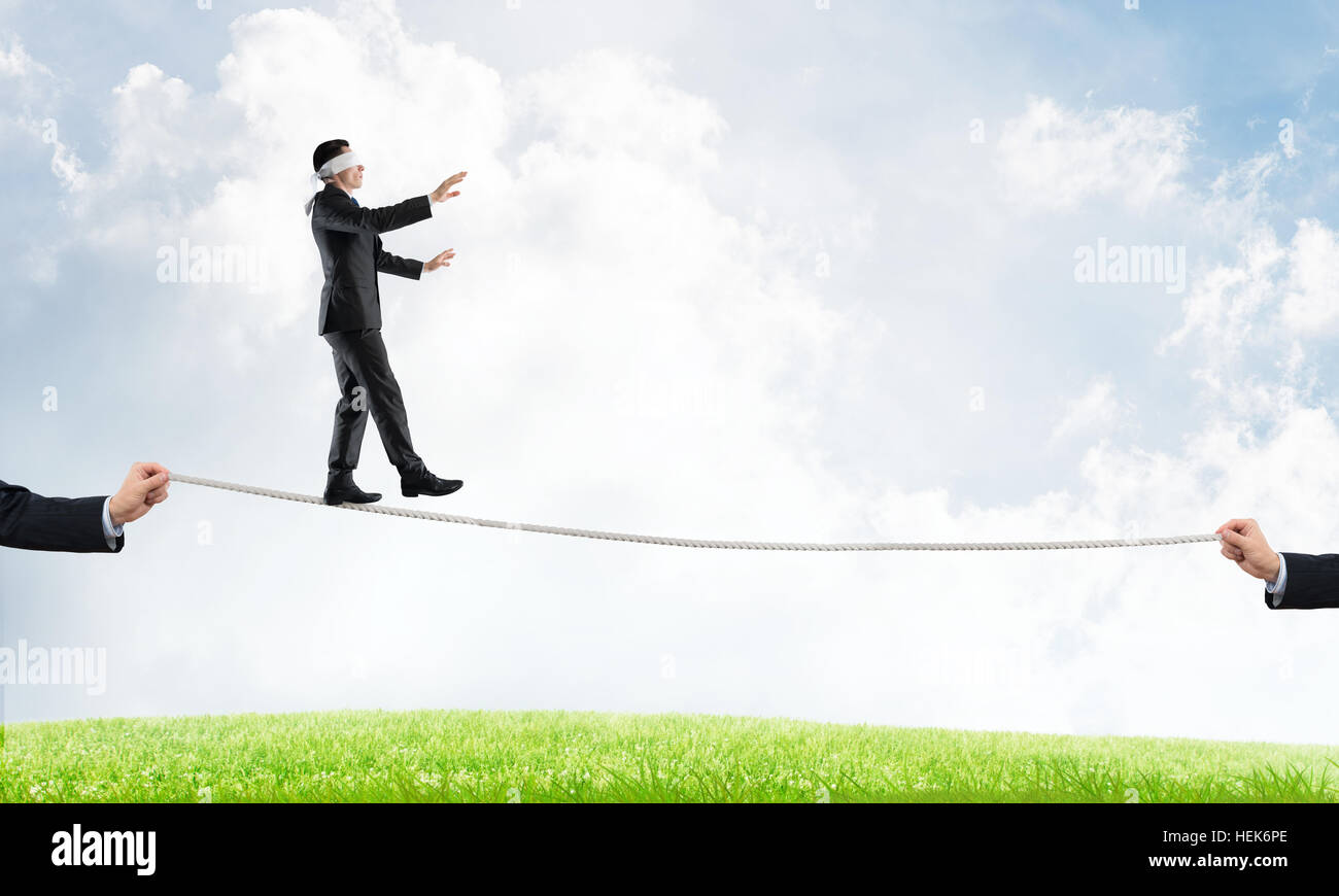 Business concept of risk support and assistance with man balancing on ...