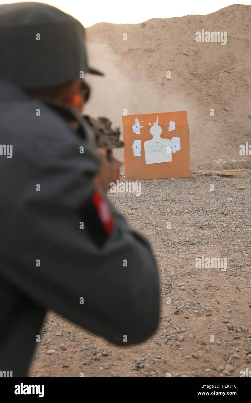 An Afghan National Police student fires his weapon during an AK-47 rifle qualification range at Forward Operating Base Tirin Kot, Uruzgan province, Afghanistan, Oct. 27, 2010. (U.S. Army photo by Staff Sgt. Tracy Hohman/Released) FOB Tirin Kot operations 101027-A-GW288-2582 Stock Photo